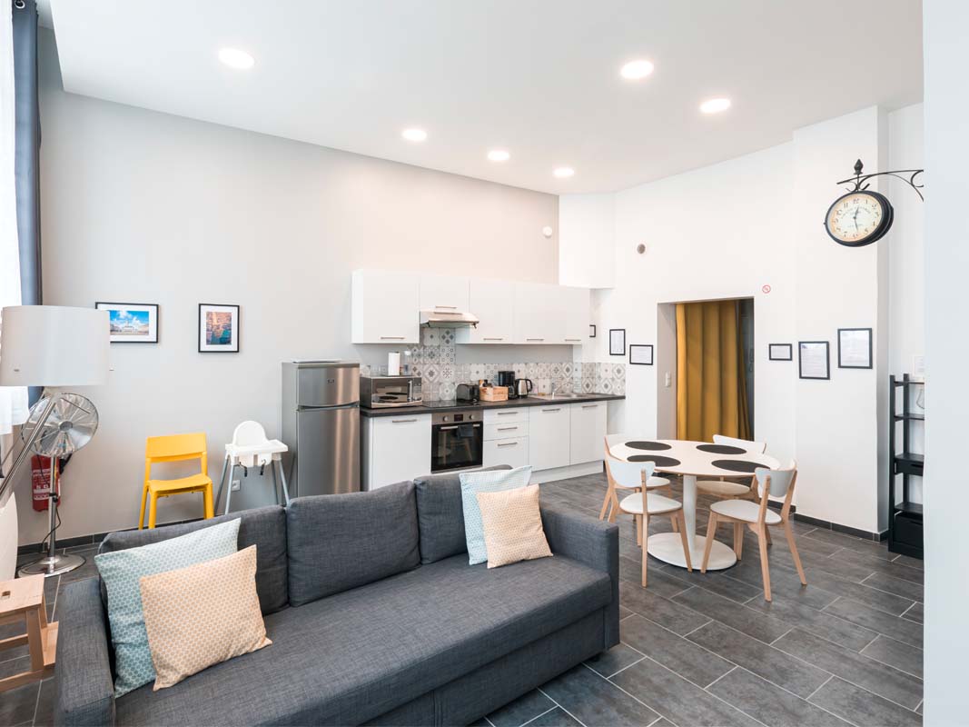 Two bedroom apartments. Scandinavian atmosphere, light walls, touches of black and yellow. White front open kitchen. High ceiling height. Rental apartment Arras by the night